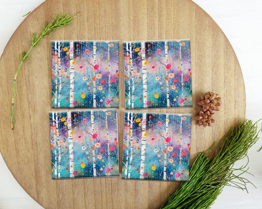 four coasters on a table with a pine cone